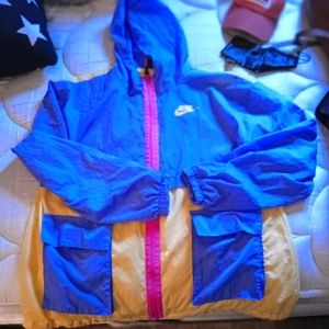 NIKE WINDBLAZER XS COLORS ARE PURPLE, PINK,AND  YELLOW